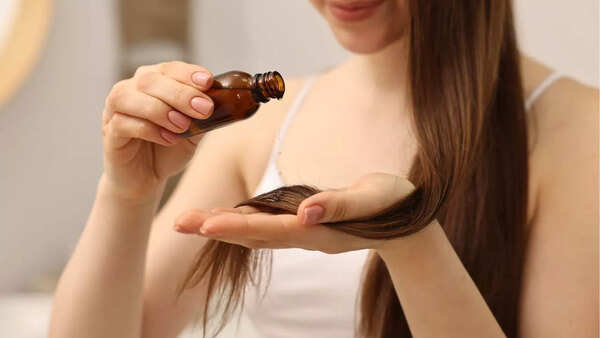 Woman massaging hair oil into her scalp.
